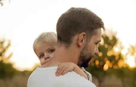 father holding his son